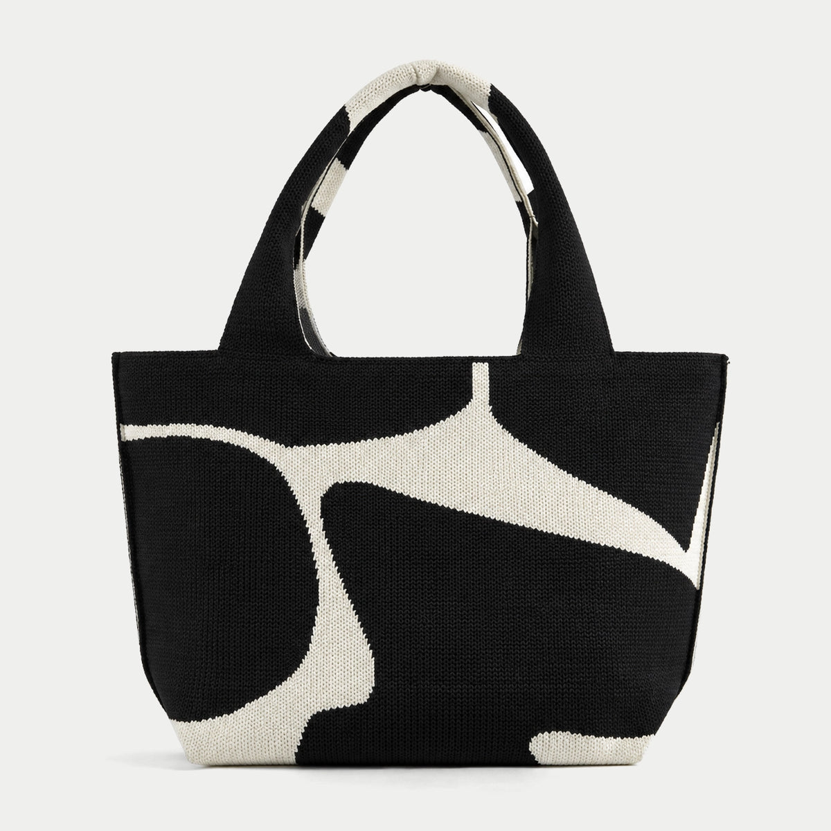 Black abstract flow pattern knit large tote bag with an oversized cream graphic and integrated knit handles by Tokeii.