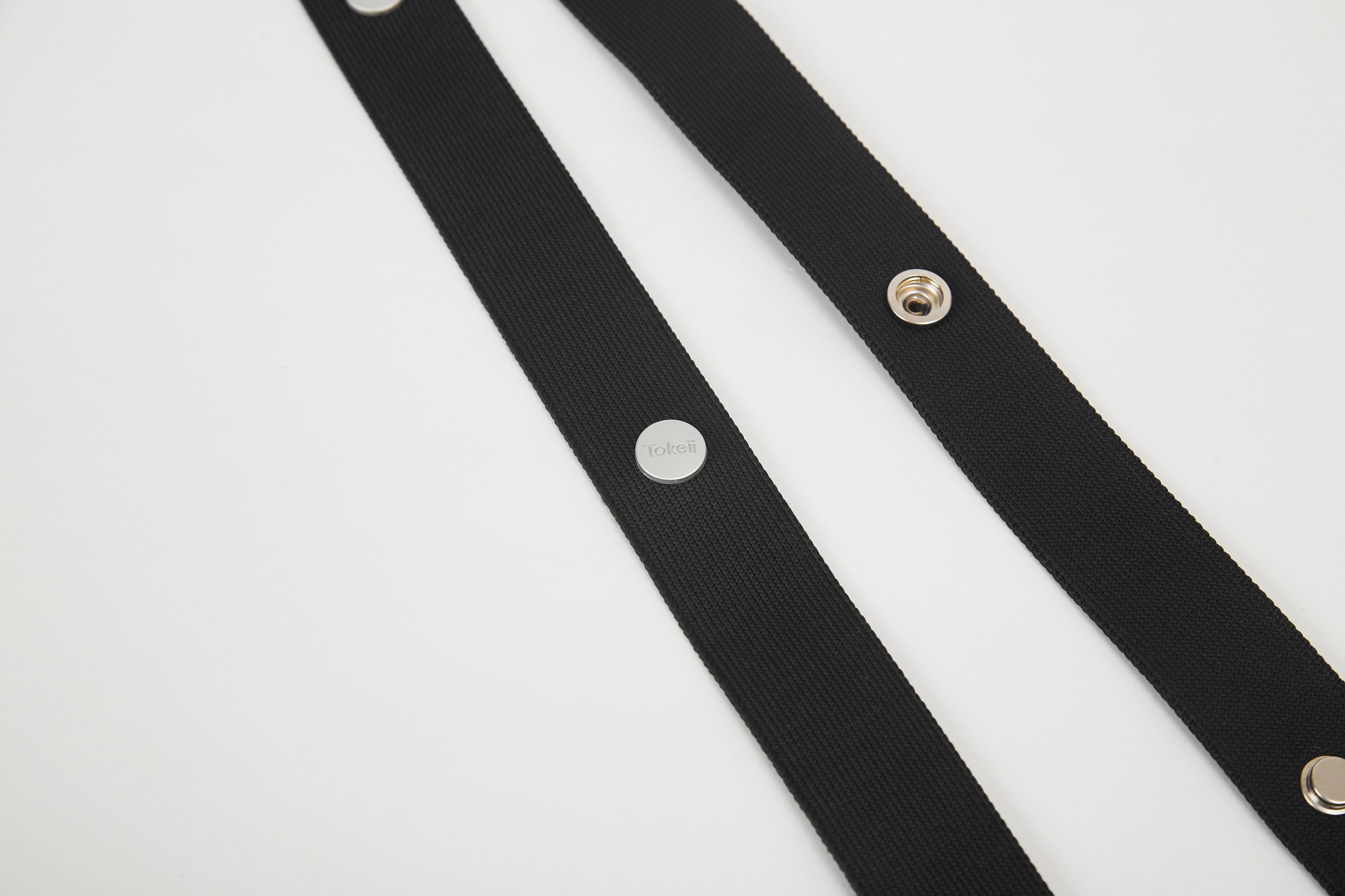 Black Colorway Strap detail with Tokeii logo hardware and snap buttons.