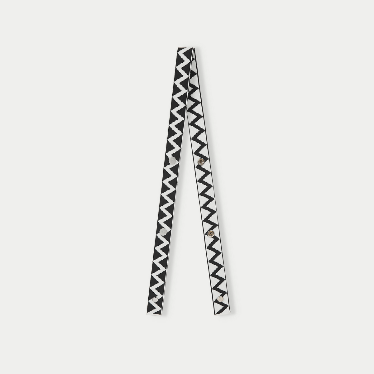 Black zigzag pattern bag strap with adjustable design and decorative geometric knit pattern.