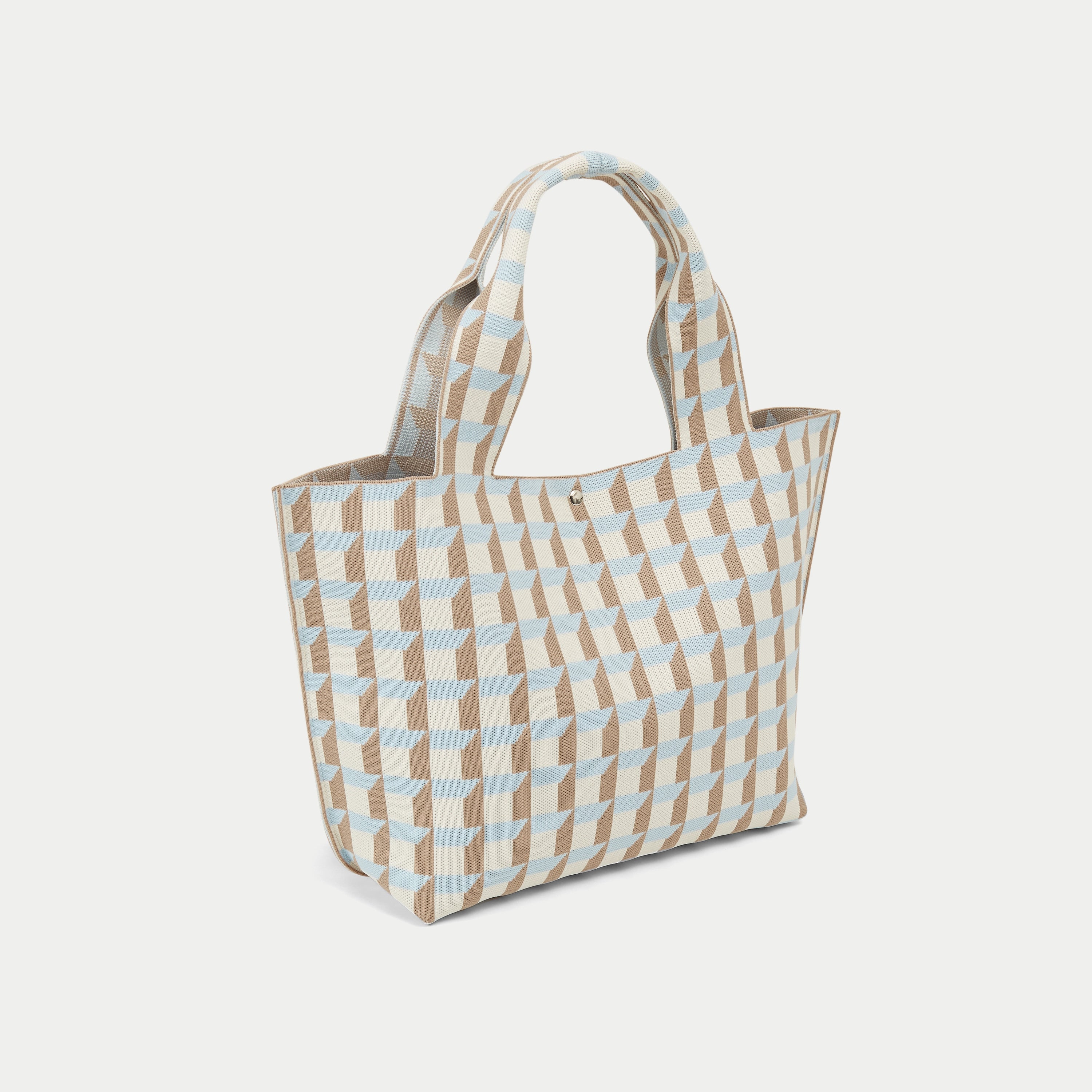 Side profile of blue and camel geometric check knitted tote bag showing its soft gusseted shape.
