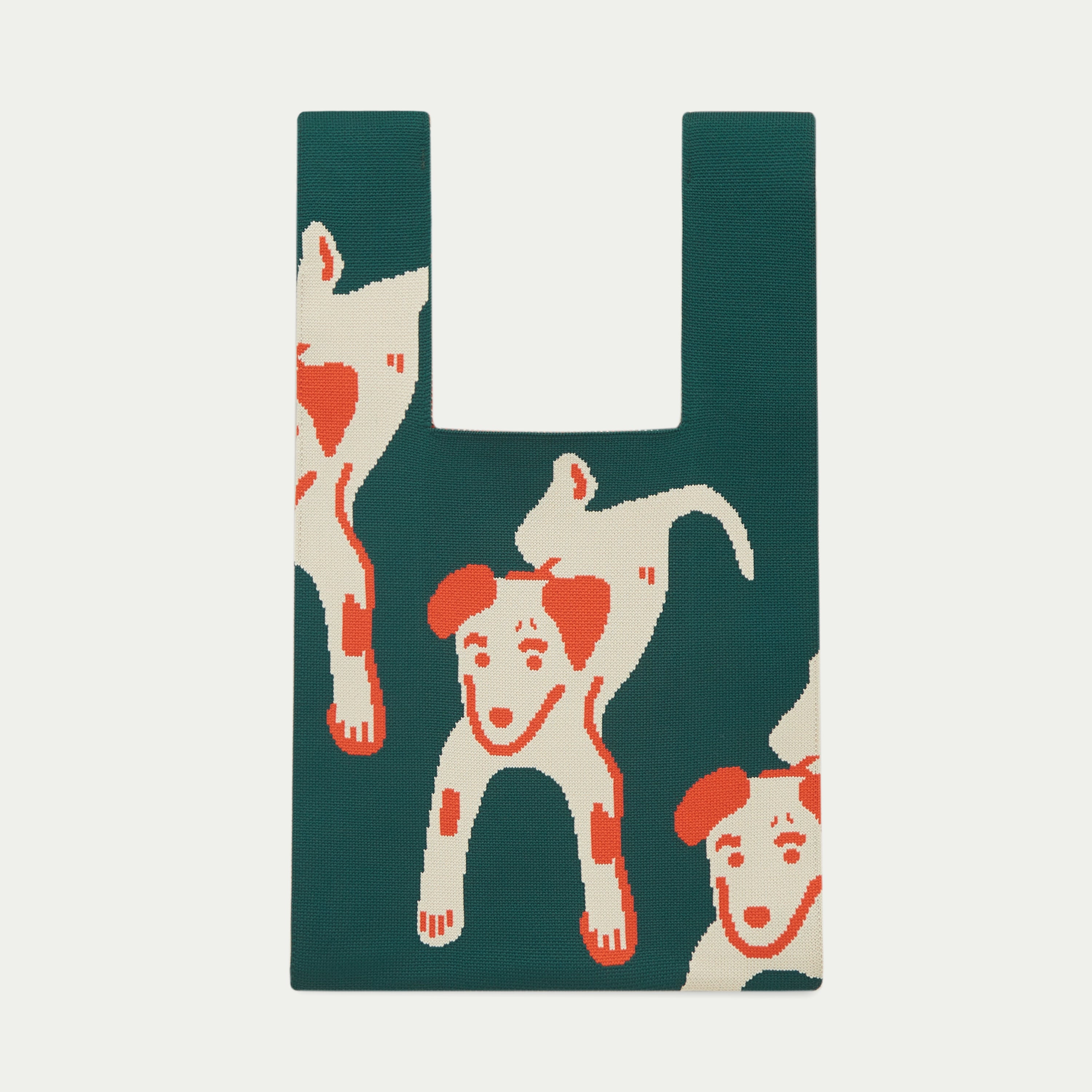 Deep green knit tote bag featuring a playful dog pattern in cream and orange, crafted with soft textured knitted fabric.