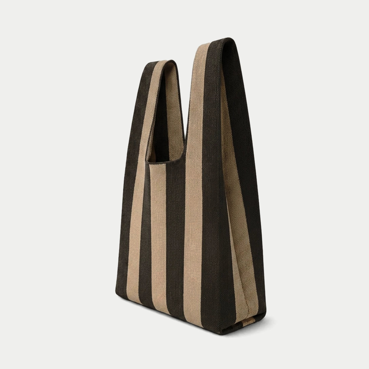 Side view of black and camel vertical stripe knitted tote bag showing the structured silhouette, handle design and textured knit construction.