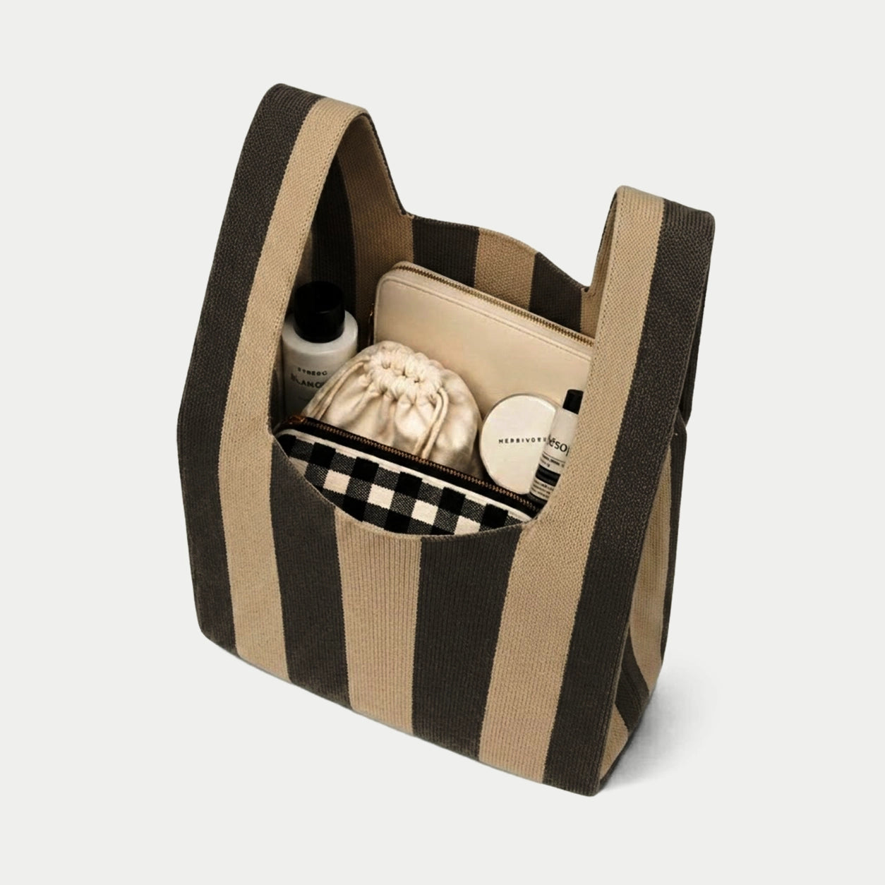 Black and camel vertical stripe knitted tote bag showing the spacious interior and capacity for carrying everyday essentials with its soft knitted construction.