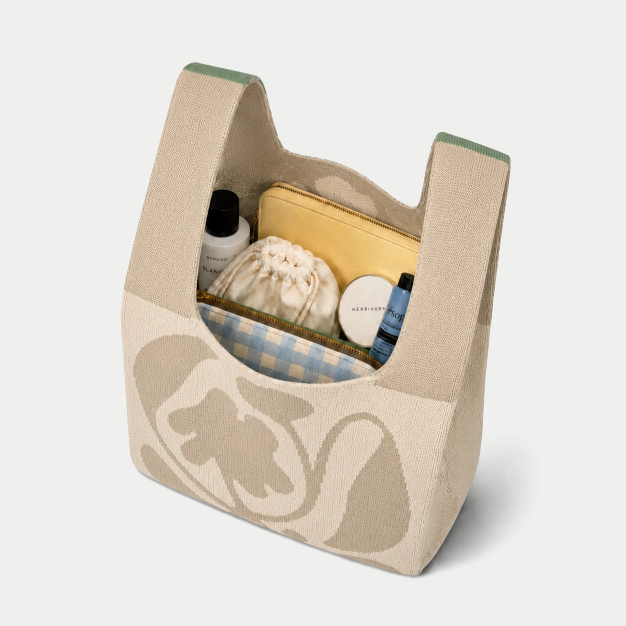 Grey oversized flower knitted tote bag showing the spacious interior and capacity for carrying everyday essentials with its soft knitted construction.