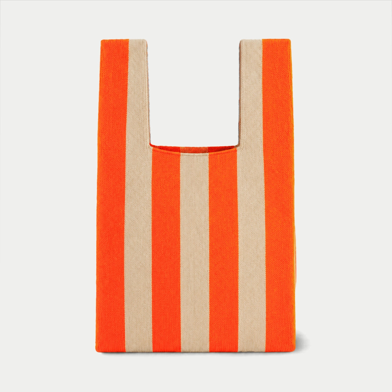 Orange vertical stripe knitted tote bag featuring a bold striped design, a lightweight everyday bag made from recycled polyester yarn.