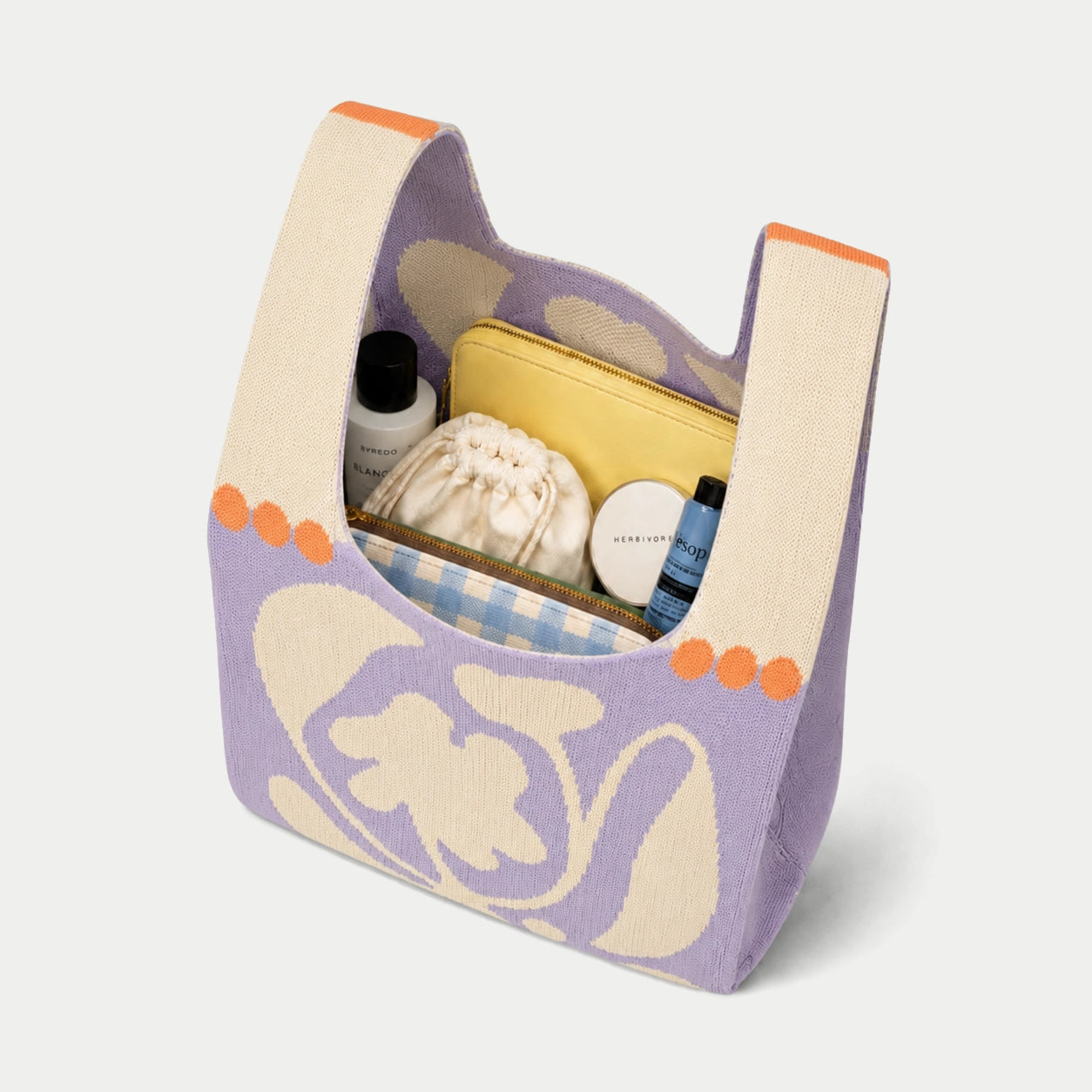 Purple oversized flower knitted tote bag showing the spacious interior and capacity for carrying everyday essentials with its soft knitted construction.