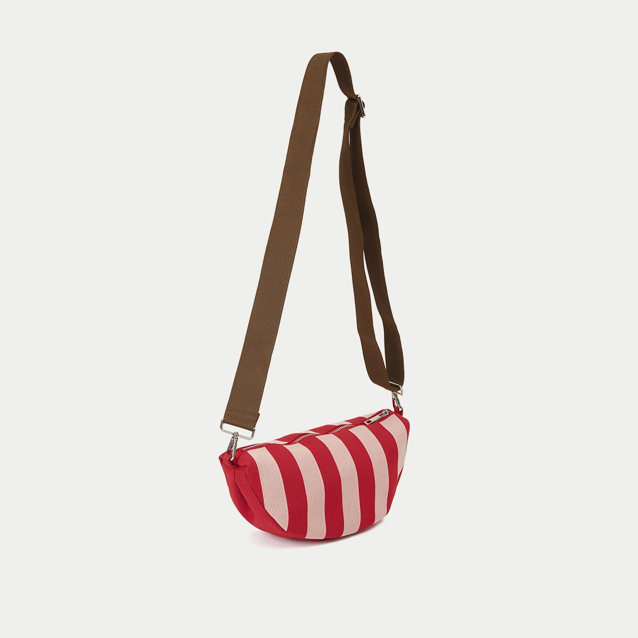 Red vertical stripe knitted half moon crossbody bag side view showing the curved profile, compact shape and adjustable strap design.