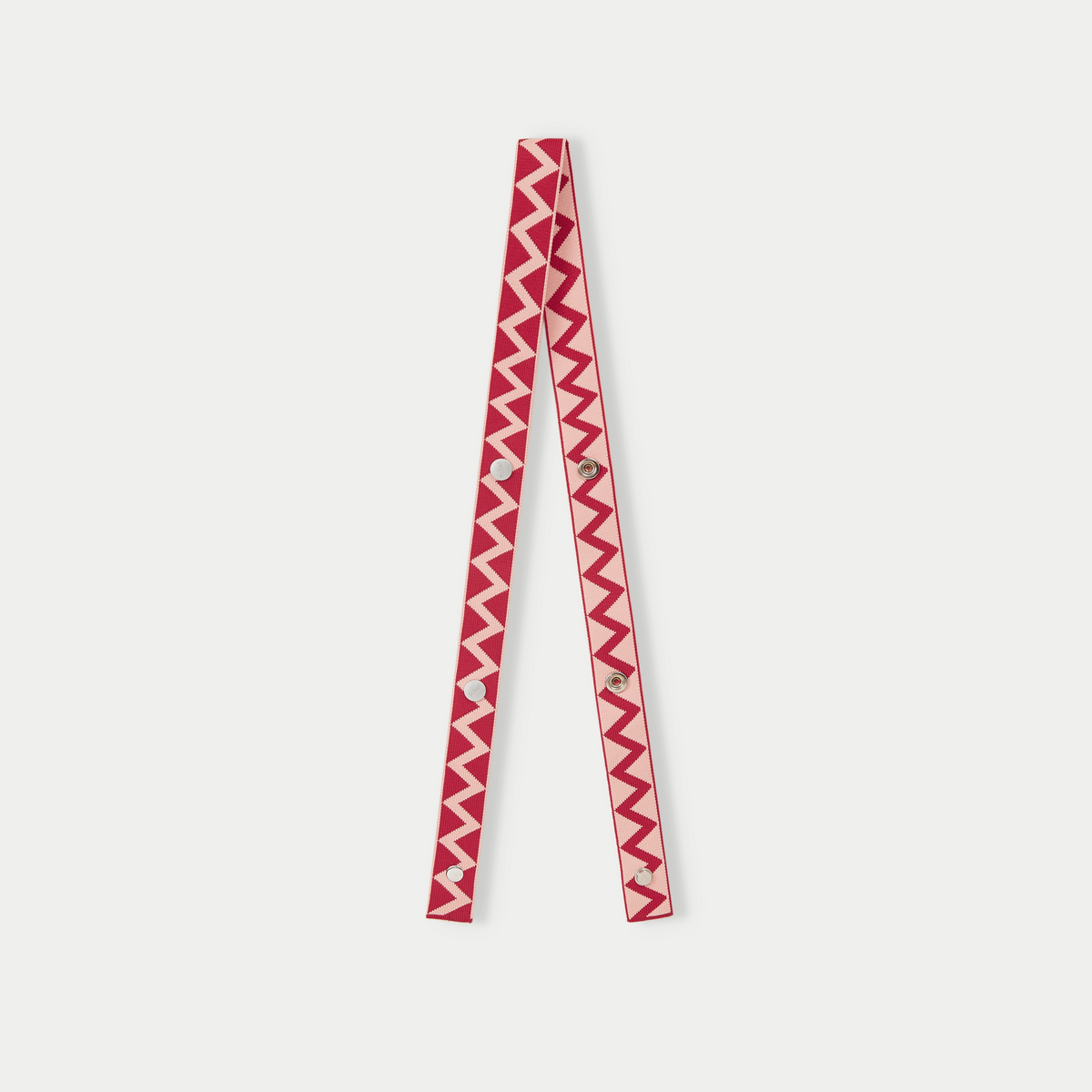 Red zigzag pattern bag strap with adjustable length and bold geometric pattern design.
