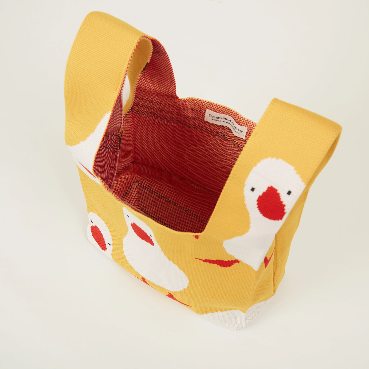 Top view of yellow duck pattern knit tote bag showing the open top, spacious interior, and detailed knitted texture.
