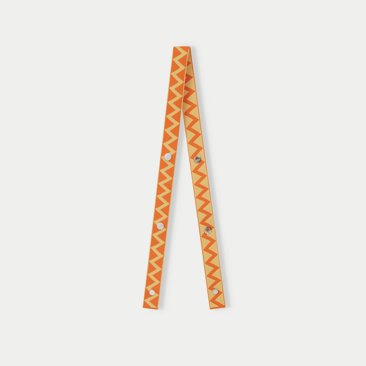 Yellow zigzag pattern bag strap with adjustable design and contrasting geometric pattern.